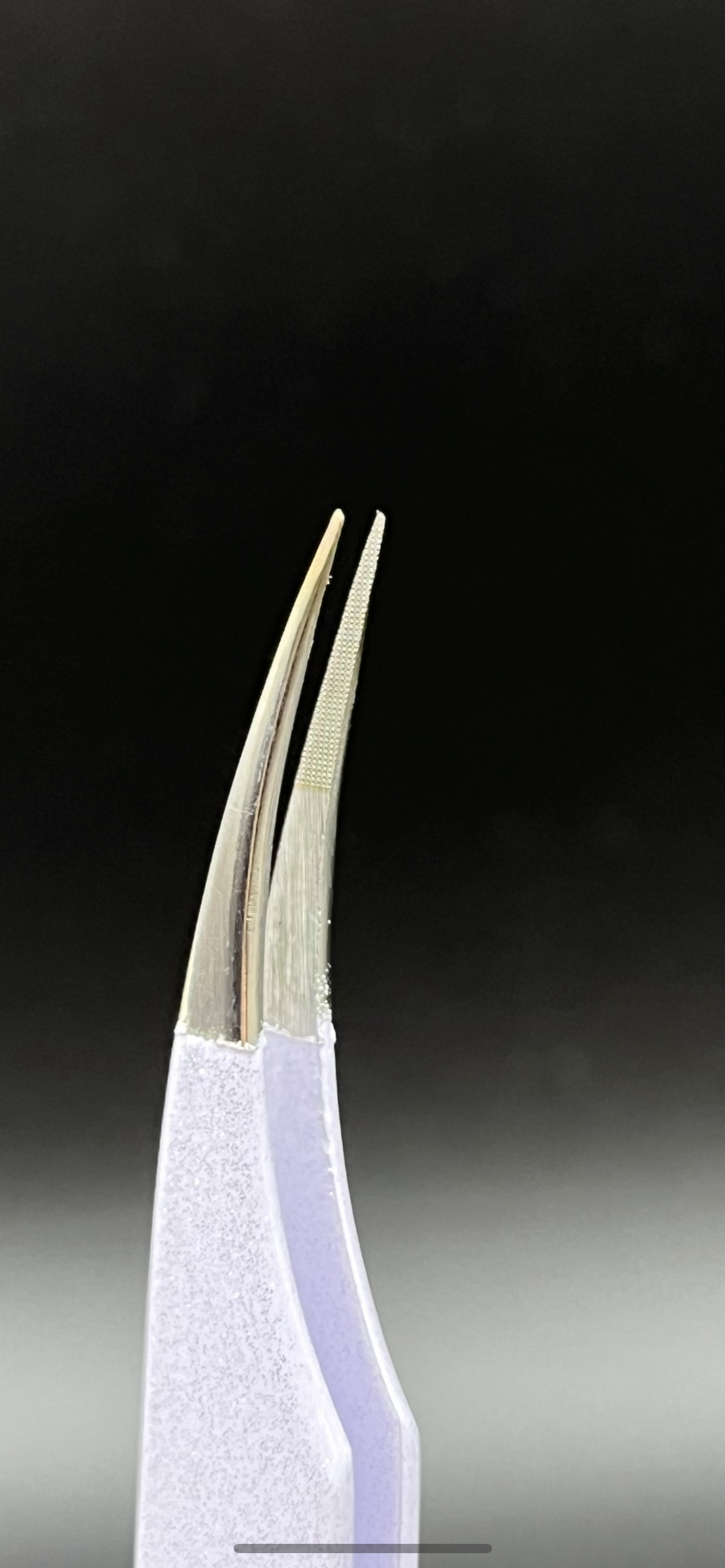 Close-up view of precision fiber tip tweezers with ergonomic handles, ideal for lash extensions and beauty professionals.