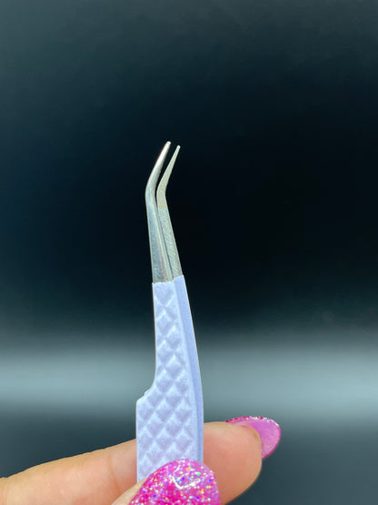 Close-up view of precision fiber tip tweezers with ergonomic handles, ideal for lash extensions and beauty professionals.